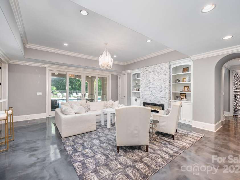 15603 June Washam Road, Davidson, NC 28036.  MLS# CAR4273381, YatesRealty ID 28502. Gas log fireplace stacked granite fireplace surround and display shelving