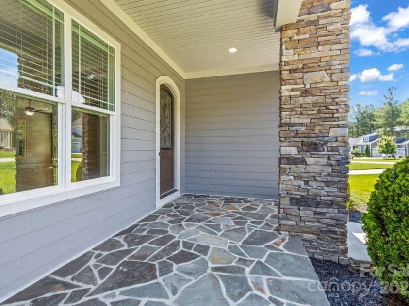 4930 Killian Crossing Drive, Denver, NC 28037.  MLS# CAR4277550, YatesRealty ID 28507. A custom arched wood entry door with wrought iron detailing sets the tone for the craftsmanship found throughout the home