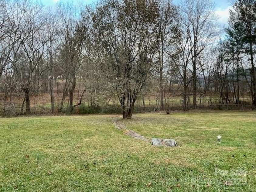 14 Spring Lake Drive, Fletcher, NC 28732.  MLS# CAR4325037, YatesRealty ID 28509. Sump pump drain in right yard