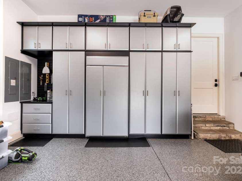 708 Amalfi Drive, Davidson, NC 28036.  MLS# CAR4281253, YatesRealty ID 28511. Extra deep 2 car garage with storage cabinets and a built in Sub-Zero refigerator/freezer