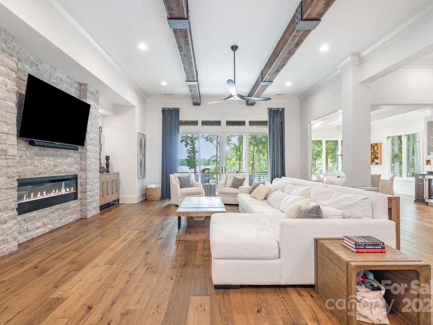 708 Amalfi Drive, Davidson, NC 28036.  MLS# CAR4281253, YatesRealty ID 28511. Sleek, linear fireplace.  Wall finished in a neutral ledgestone.