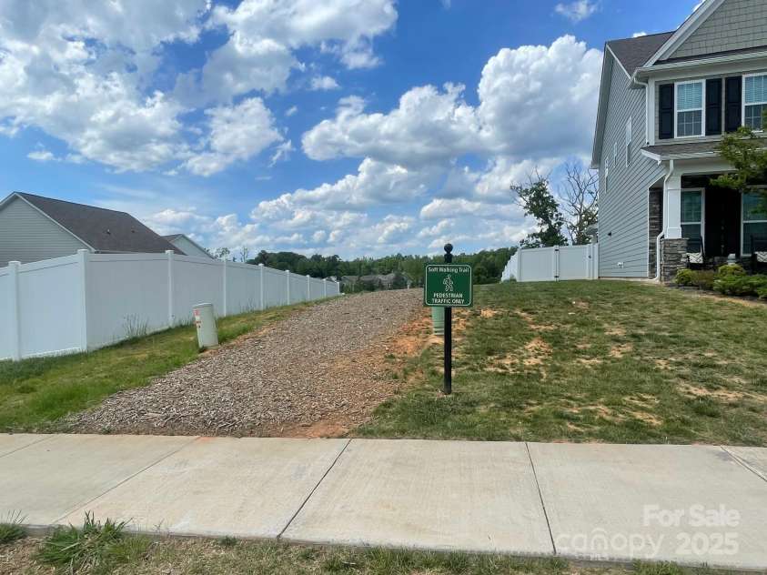 128 Championship Drive, Mooresville, NC 28115.  MLS# CAR4253637, YatesRealty ID 28518. Walking trail entrance a few doors down
