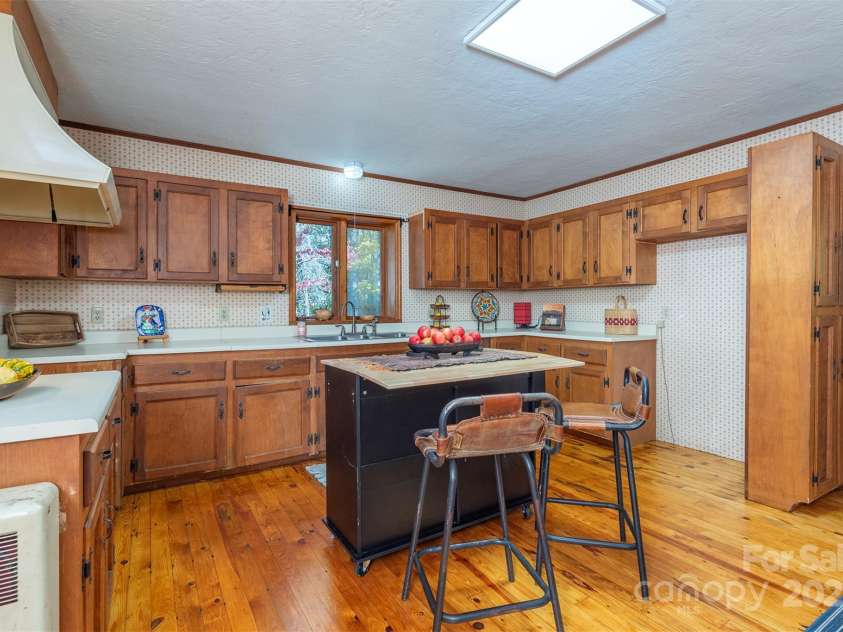 102 Weaver Mill Road, Columbus, NC 28722.  MLS# CAR4211548, YatesRealty ID 2852. This spacious kitchen with original, newly refinished floors, is spacious enough to prepare for large or small gatherings.