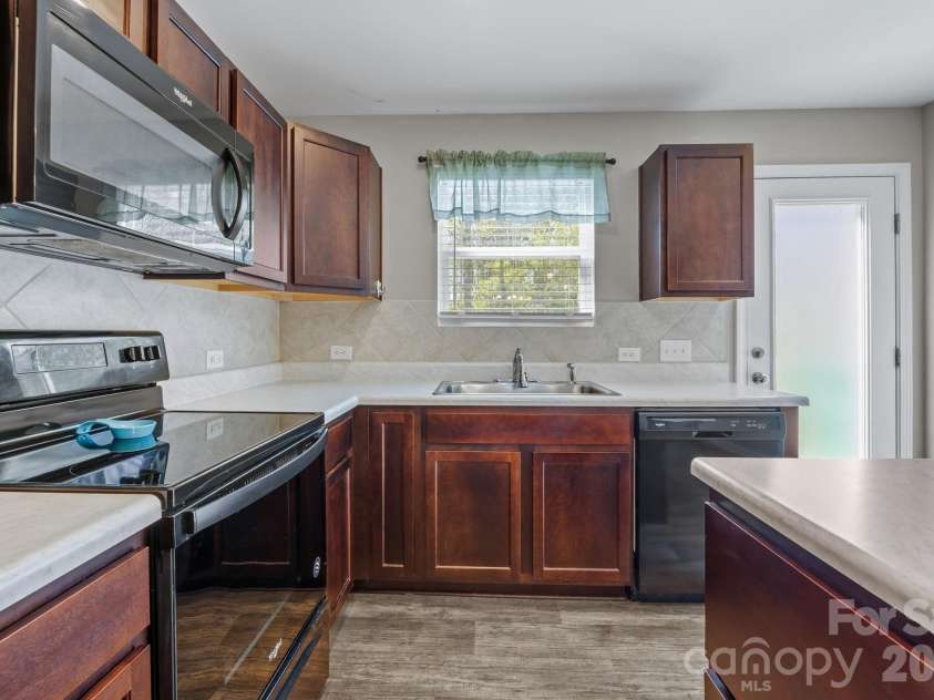 813 Yorkshire Drive, Albemarle, NC 28001.  MLS# CAR4390673, YatesRealty ID 28525. Bright and airy kitchen overlooking the backyard