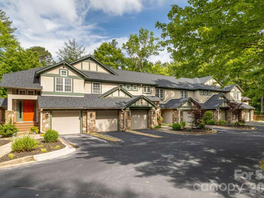 99 Ridgetop Circle, Brevard, NC 28712.  MLS# CAR4387560, YatesRealty ID 28540. Building Exterior & Setting – Endearing mountain-inspired architecture surrounded by mature trees and professionally maintained grounds.