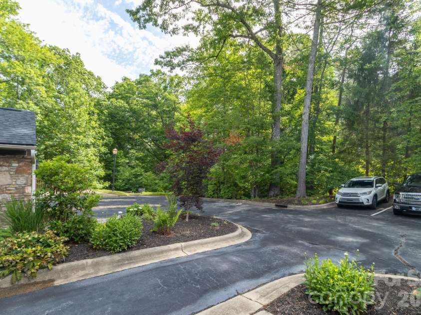 99 Ridgetop Circle, Brevard, NC 28712.  MLS# CAR4387560, YatesRealty ID 28540. Community Parking & Common Area – Ample guest parking and beautifully landscaped common areas surrounded by mature hardwoods for a private mountain feel.