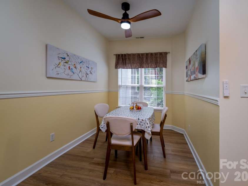 99 Ridgetop Circle, Brevard, NC 28712.  MLS# CAR4387560, YatesRealty ID 28540. Dining Area / Flex Space – Bright dining area with wooded views, ideal for formal dining, casual meals, or flexible use as a sitting or office space.