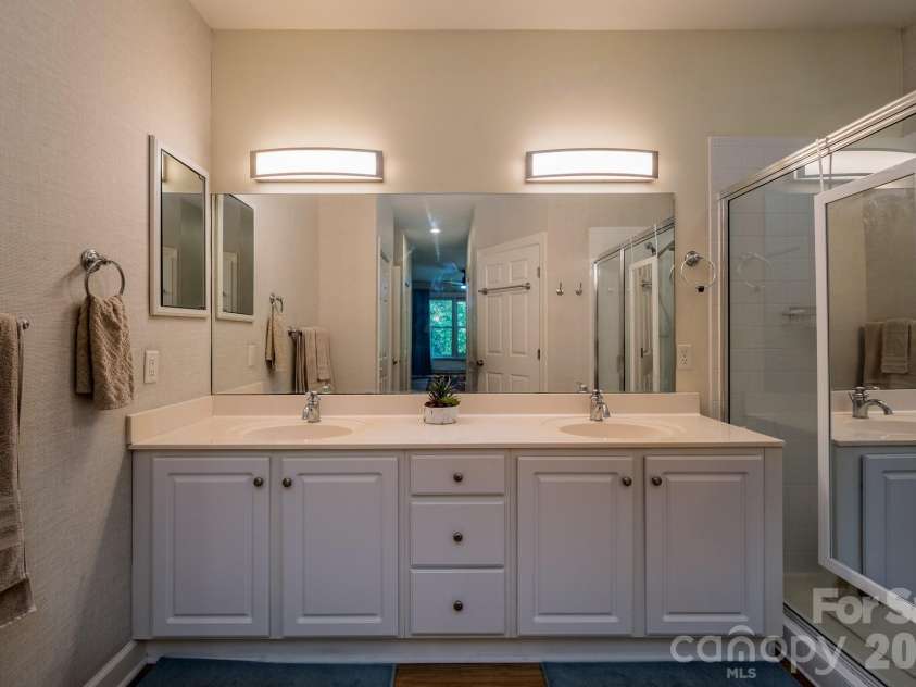 99 Ridgetop Circle, Brevard, NC 28712.  MLS# CAR4387560, YatesRealty ID 28540. Dual Vanity Primary Bath – Expansive en-suite bathroom with double vanity, generous counter space, and bright lighting for added convenience.