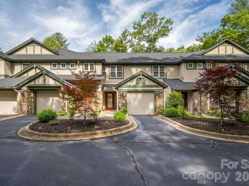 99 Ridgetop Circle, Brevard, NC 28712.  MLS# CAR4387560, YatesRealty ID 28540.  Exterior Building Perspective – Well-maintained building exterior showcasing attractive architecture, private garage, and beautifully landscaped common areas.