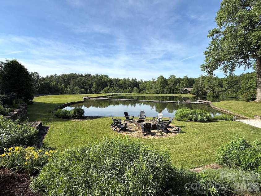 99 Ridgetop Circle, Brevard, NC 28712.  MLS# CAR4387560, YatesRealty ID 28540. Lakeside Fire Pit Gathering Area – Enjoy evenings by the community lakeside fire pit, surrounded by manicured grounds, peaceful water views, and inviting seating perfect for gathering with friends and neighbors.