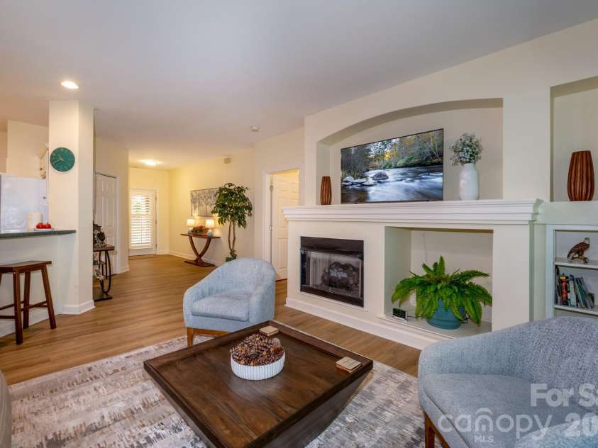 99 Ridgetop Circle, Brevard, NC 28712.  MLS# CAR4387560, YatesRealty ID 28540.  Open Living Area – Inviting open-concept living space with fireplace focal point, abundant natural light, and an easy flow to the kitchen and foyer.