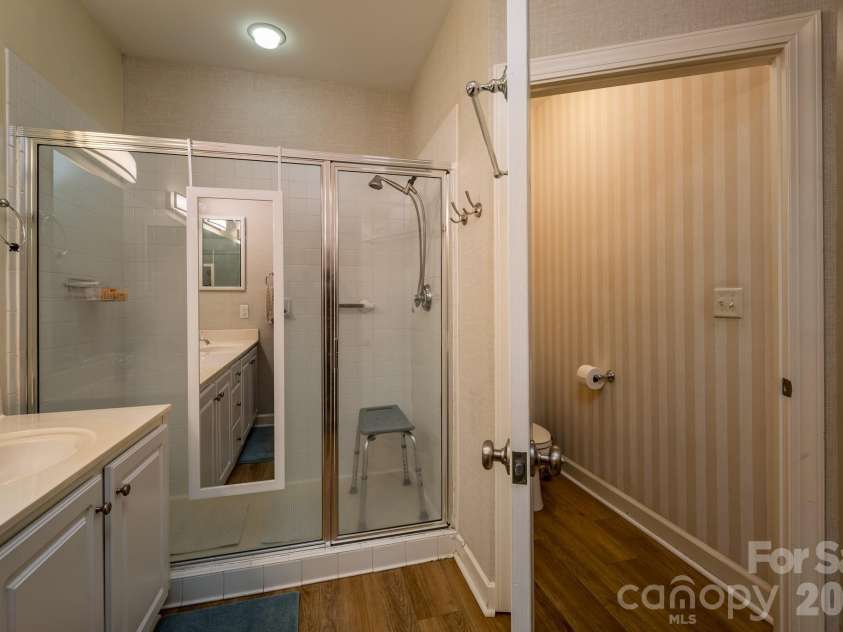 99 Ridgetop Circle, Brevard, NC 28712.  MLS# CAR4387560, YatesRealty ID 28540. Primary Bathroom with Walk-In Shower – Spacious primary bath featuring a large walk-in shower, private water closet, and functional layout.