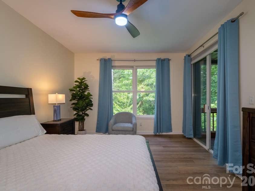 99 Ridgetop Circle, Brevard, NC 28712.  MLS# CAR4387560, YatesRealty ID 28540. Primary Suite with Screened Porch Access – Comfortable primary bedroom with direct access to the screened porch, creating a seamless indoor-outdoor retreat.