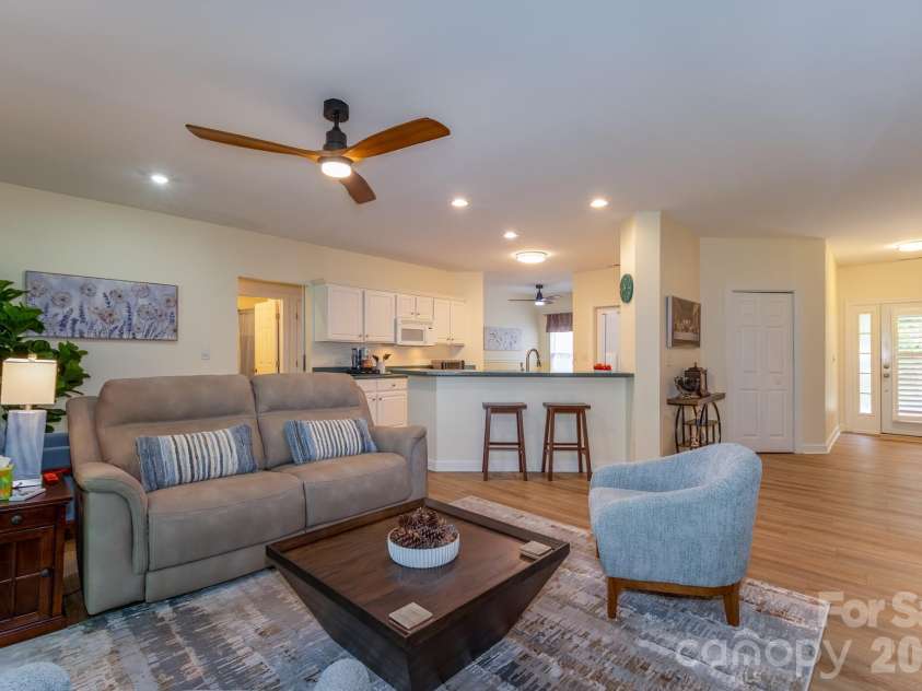 99 Ridgetop Circle, Brevard, NC 28712.  MLS# CAR4387560, YatesRealty ID 28540. Spacious Open Floor Plan – Bright and open living room with updated flooring, modern ceiling fan, breakfast bar seating, and excellent flow for entertaining.