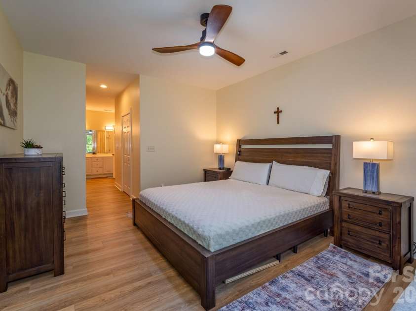 99 Ridgetop Circle, Brevard, NC 28712.  MLS# CAR4387560, YatesRealty ID 28540. Spacious Primary Suite – Generously sized primary bedroom featuring ample space for furnishings, warm natural light, and easy access to the en-suite bath.