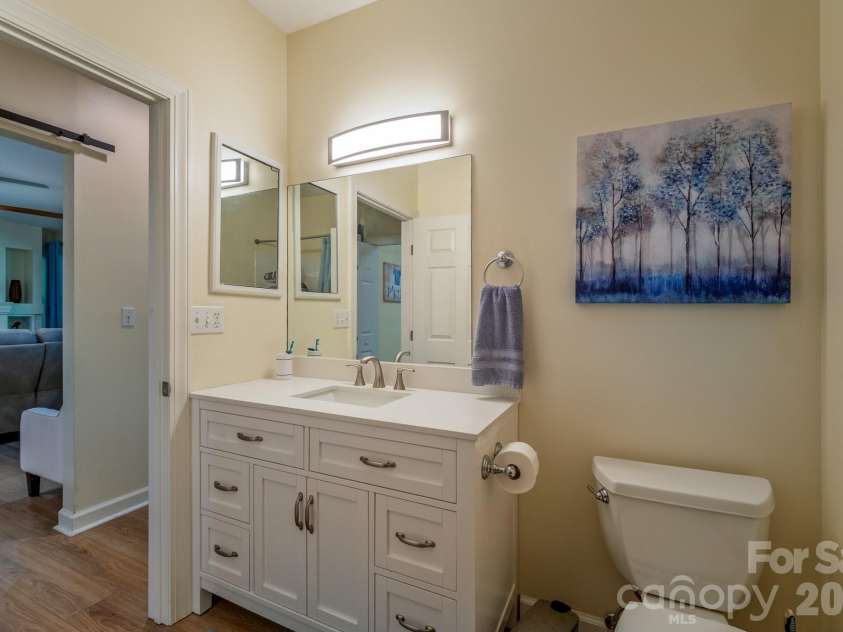 99 Ridgetop Circle, Brevard, NC 28712.  MLS# CAR4387560, YatesRealty ID 28540. Updated Bathroom Vanity – Updated bathroom with stylish vanity, modern lighting, and direct access from the main living area and guest spaces.