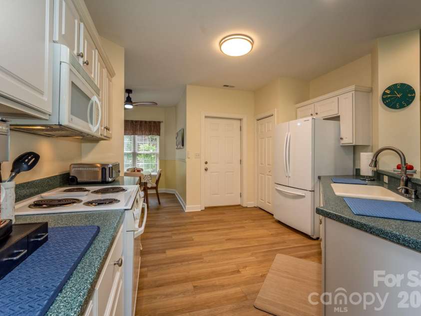 99 Ridgetop Circle, Brevard, NC 28712.  MLS# CAR4387560, YatesRealty ID 28540. Well-Appointed Kitchen – Bright kitchen with plentiful cabinetry, pantry storage, and a functional layout opening to the dining area.