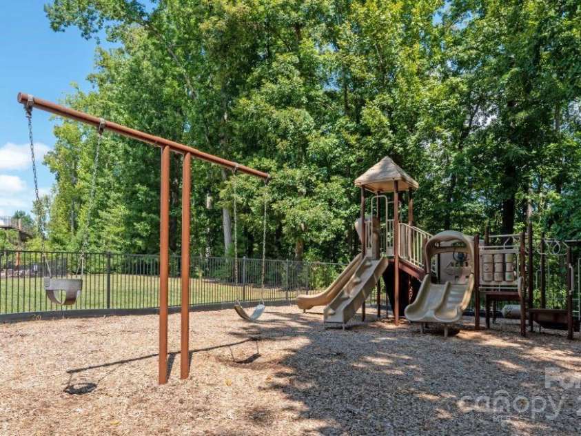 3140 Seville Street, Charlotte, NC 28214.  MLS# CAR4285079, YatesRealty ID 28543. Neighborhood park featuring swings, slides, and green space