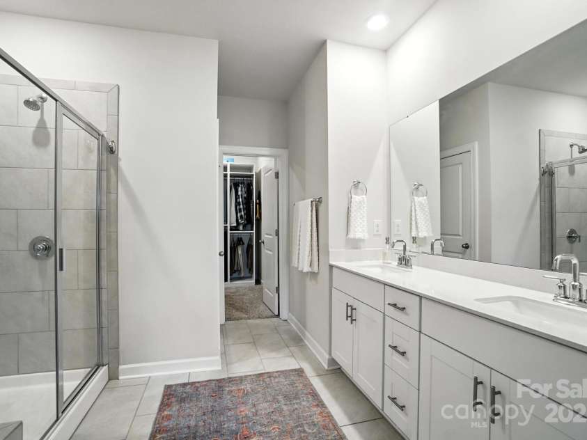3140 Seville Street, Charlotte, NC 28214.  MLS# CAR4285079, YatesRealty ID 28543. Spa-like bath featuring dual sinks, walk-in shower, and private water closet