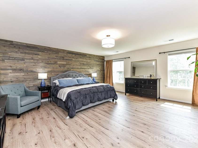 11730 Maher Lane, Huntersville, NC 28078.  MLS# CAR4281709, YatesRealty ID 28558. Huge Primary Suite on upper level features wood accent wall, private bath, walk in closet & great natural light!