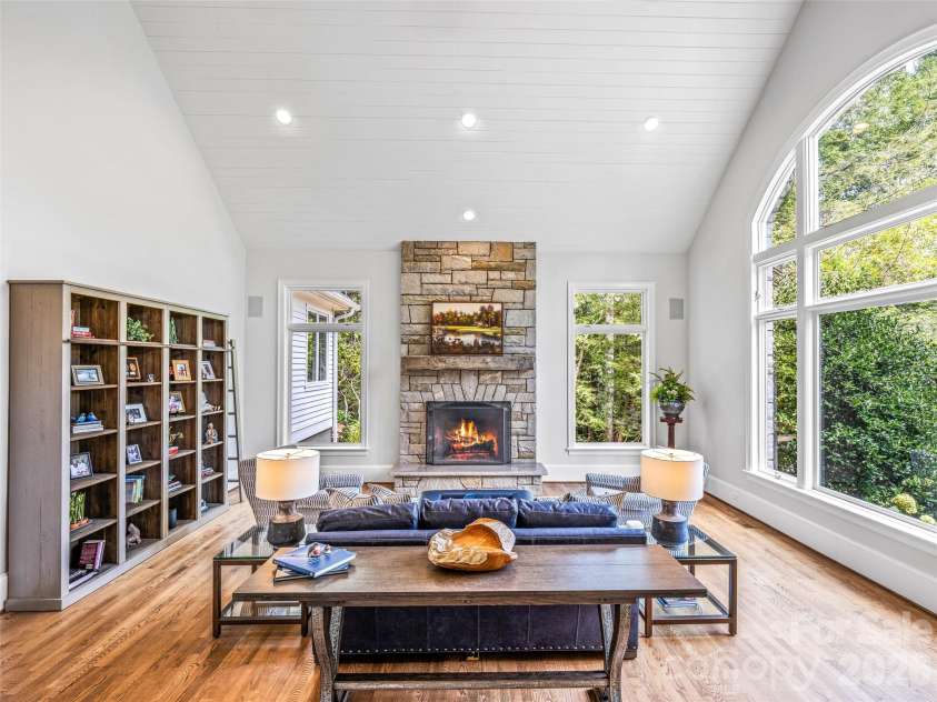 4 Cedar Hill Drive, Asheville, NC 28803.  MLS# CAR4390300, YatesRealty ID 28593. A stone fireplace and soaring ceilings with a framed mountain view