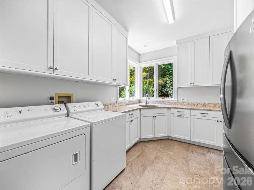 4 Cedar Hill Drive, Asheville, NC 28803.  MLS# CAR4390300, YatesRealty ID 28593. The spacious laundry room has an extra fridge and storage