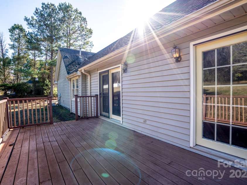 151 Oak Point Drive, Cherryville, NC 28021.  MLS# CAR4135718, YatesRealty ID 2860. Back deck, the dining room entrance is next to the deck entrance to the backyard.