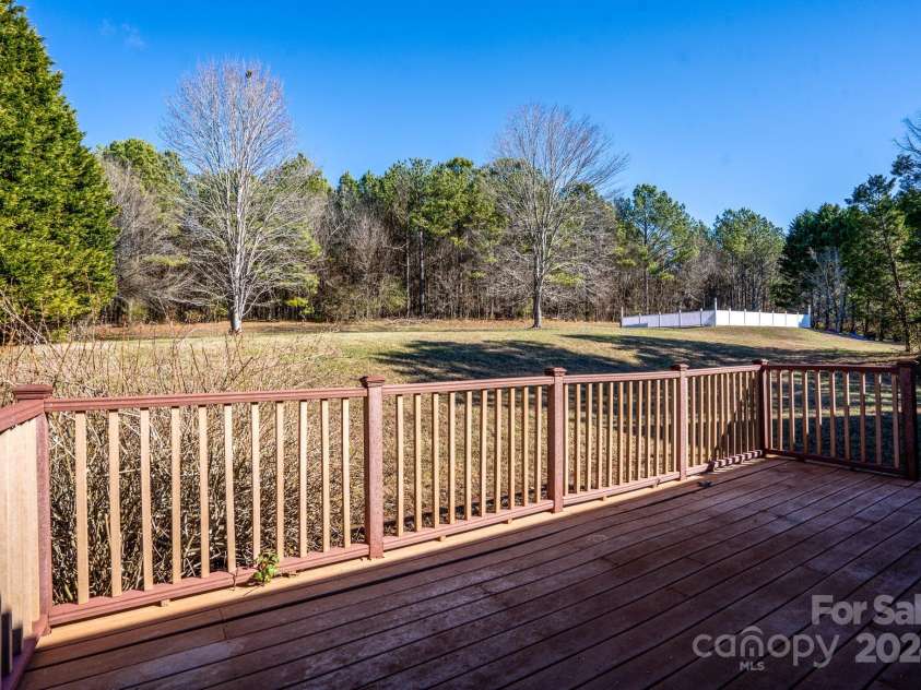 151 Oak Point Drive, Cherryville, NC 28021.  MLS# CAR4135718, YatesRealty ID 2860. Here's that 11' x 21' deck and quiet backyard view. There are multiple seasonal Moss Lake delightful viewing locations in this backyard.