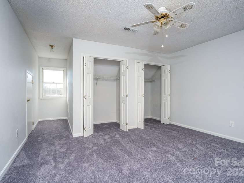 151 Oak Point Drive, Cherryville, NC 28021.  MLS# CAR4135718, YatesRealty ID 2860. Middle Bedroom has two closets, and the other door is access to storage space.