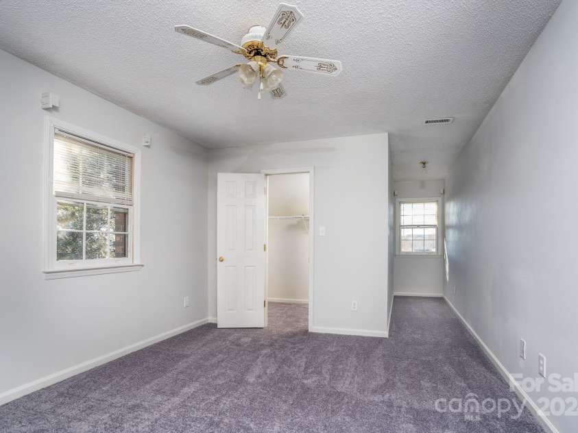 151 Oak Point Drive, Cherryville, NC 28021.  MLS# CAR4135718, YatesRealty ID 2860. Upstairs right bedroom with a walk-in closet and window views of Moss Lake. There is also attic storage of 128 SQFT.