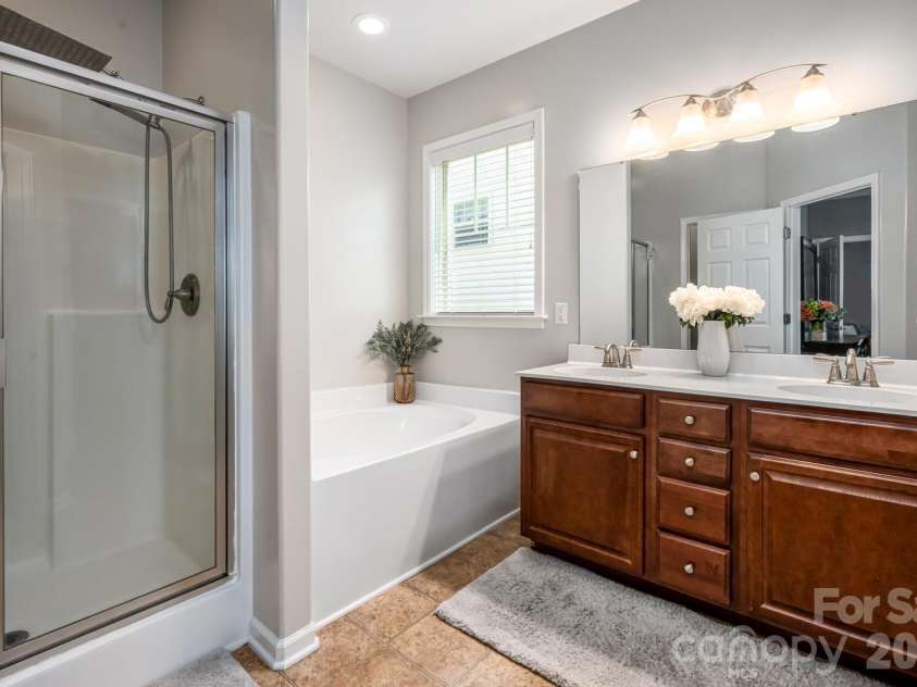 9 Partridge Berry Lane, Weaverville, NC 28787.  MLS# CAR4375602, YatesRealty ID 28605. Primary bathroom with dual vanity.