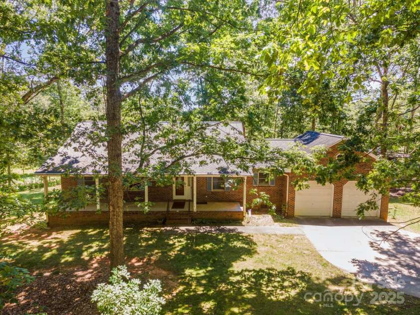 2155 Randolph Road, Shelby, NC 28150.  MLS# CAR4275104, YatesRealty ID 28608. Mature trees surround the home and property.