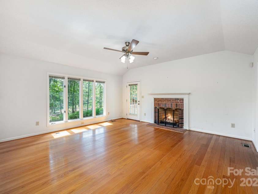 2155 Randolph Road, Shelby, NC 28150.  MLS# CAR4275104, YatesRealty ID 28608. The large living room has gas fireplace, large windows, vaulted ceiling...
