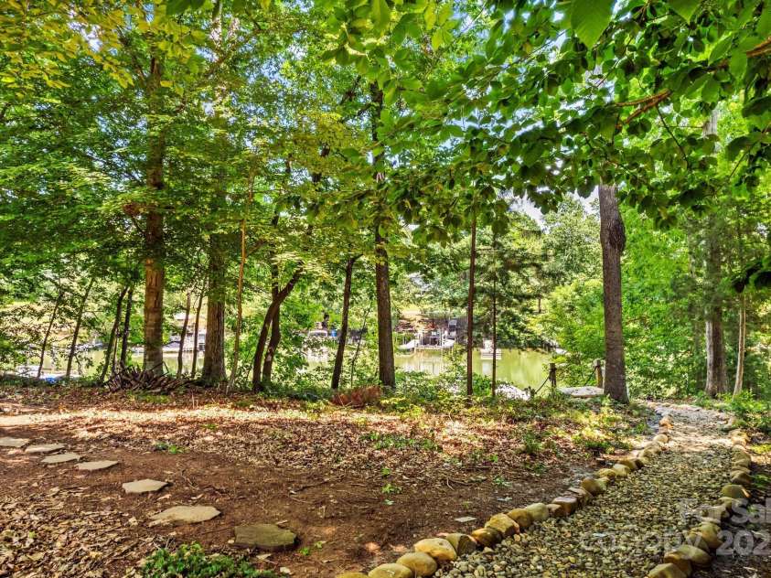 110 Preserve Way, Mooresville, NC 28117.  MLS# CAR4250582, YatesRealty ID 28619. Path from backyard to your own dock on Lake Norman.