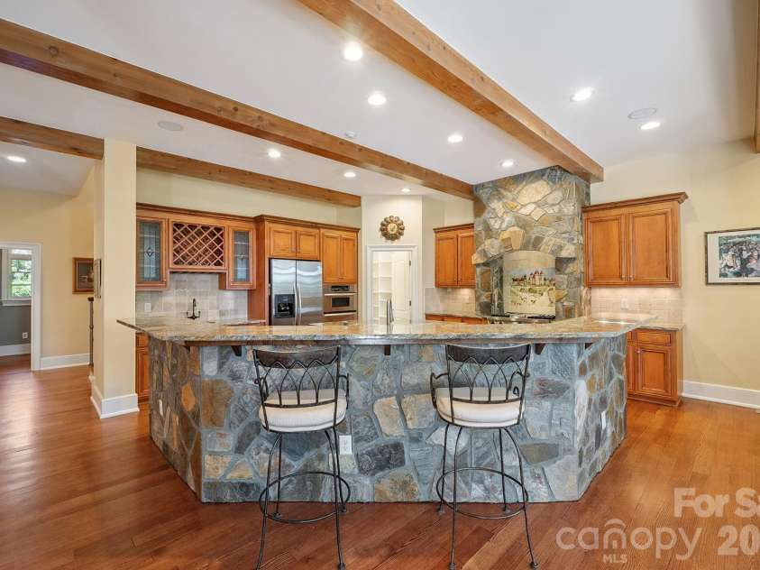 1515 Baltusrol Drive, Denver, NC 28037.  MLS# CAR4224856, YatesRealty ID 28621. Dramatic Natural Stone Exhaust Hood and Flagstone Kneewall at Breakfast Bar. 
