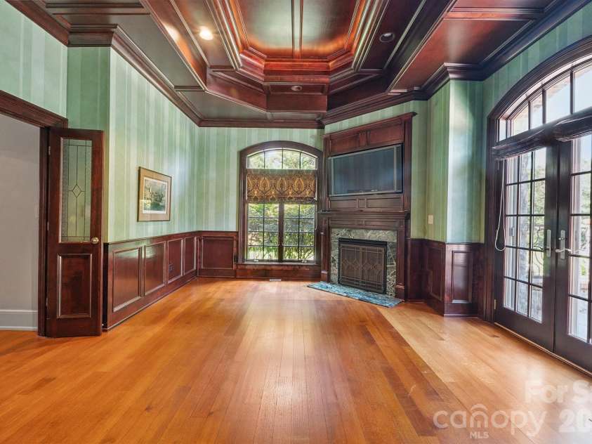 1515 Baltusrol Drive, Denver, NC 28037.  MLS# CAR4224856, YatesRealty ID 28621. Formal Study in Primary Suite with French Door Entry, Rich Wood Paneling, Gas Fireplace, and Private Flagstone Porch.