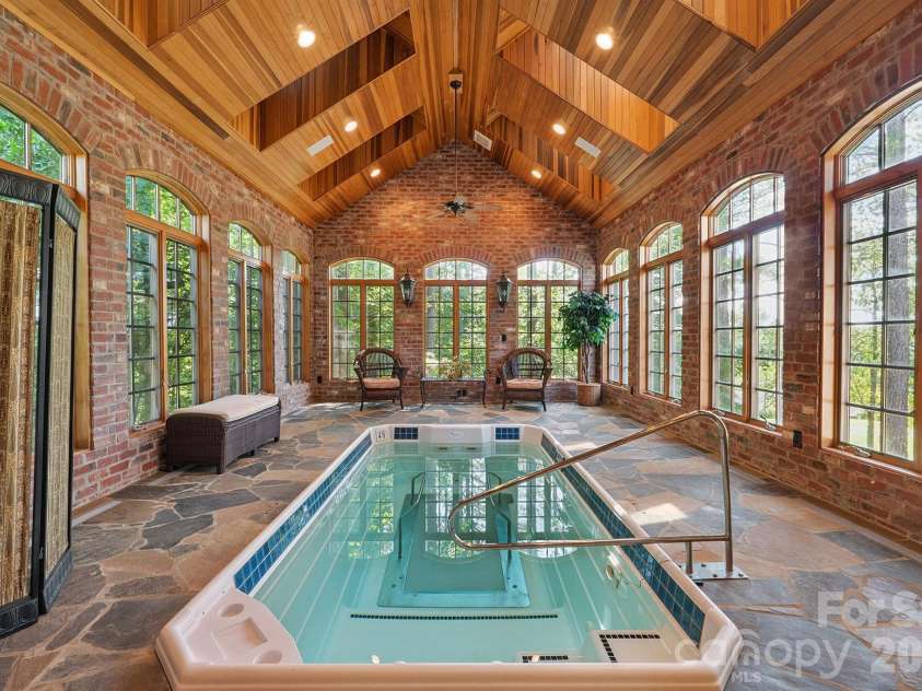 1515 Baltusrol Drive, Denver, NC 28037.  MLS# CAR4224856, YatesRealty ID 28621. Stunning Fitness Pool Room with Exposed Brick, Flagstone Deck and Wood Paneled Vaulted Ceiling.
