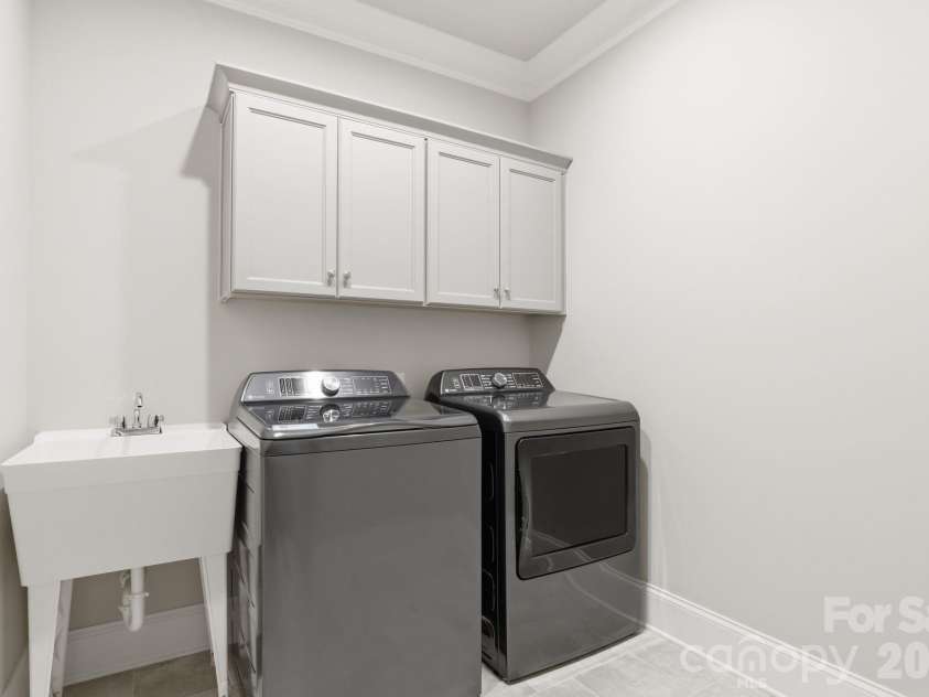 9823 Ardley Park Way, Mint Hill, NC 28227.  MLS# CAR4387355, YatesRealty ID 28629. Functional laundry with sink and storage