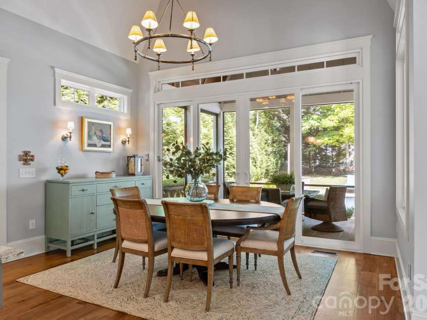 20727 Pointe Regatta Drive, Cornelius, NC 28031.  MLS# CAR4370865, YatesRealty ID 28632. Dining area features sliding doors opening to a screened porch.