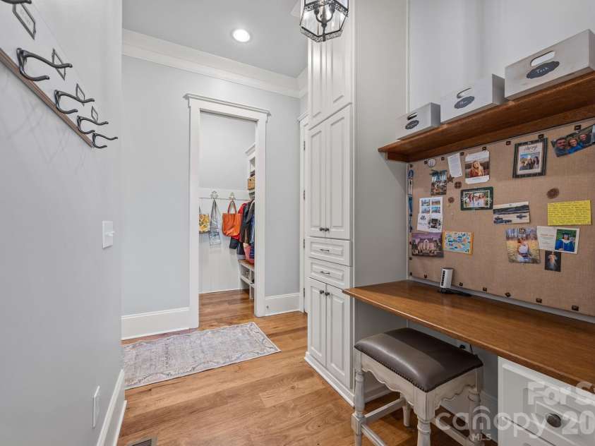 20727 Pointe Regatta Drive, Cornelius, NC 28031.  MLS# CAR4370865, YatesRealty ID 28632. Functional drop zone includes built-in desk, storage cabinetry, and access to a walk-in closet area.