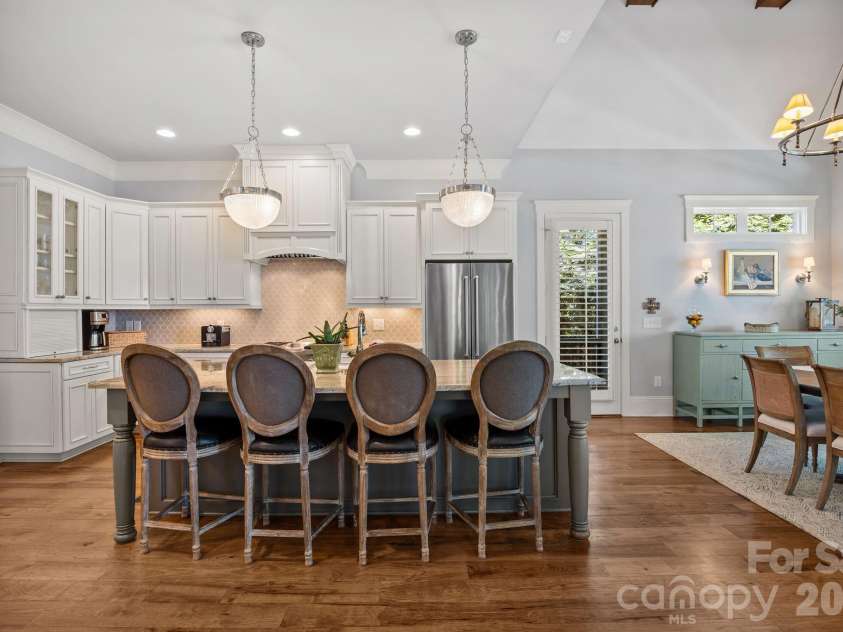 20727 Pointe Regatta Drive, Cornelius, NC 28031.  MLS# CAR4370865, YatesRealty ID 28632. Open kitchen with large island, pendant lighting, custom cabinetry, and adjacent dining area.