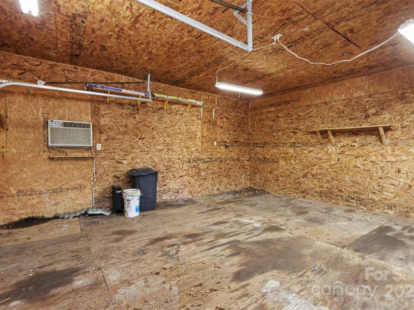 119 Moore Drive, Gastonia, NC 28056.  MLS# CAR4332115, YatesRealty ID 2865. Spacious detached garage offering excellent versatility for parking, storage, or workshop use. The interior features durable wood flooring, ample lighting, and generous open space ideal for projects, hobbies, or equipment st