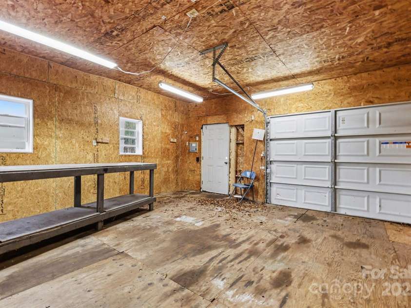 119 Moore Drive, Gastonia, NC 28056.  MLS# CAR4332115, YatesRealty ID 2865. The detached garage also includes built-in work surfaces and shelving add functionality, while the enclosed structure provides year-round usability, perfect for car enthusiasts, craftsmen, or additional storage needs.