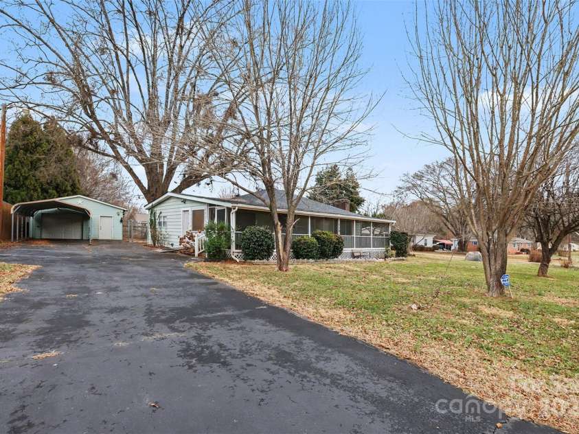 119 Moore Drive, Gastonia, NC 28056.  MLS# CAR4332115, YatesRealty ID 2865. The extended drive way leads to a detached garage with covered carport, providing flexibility for vehicles, storage, or a workshop.