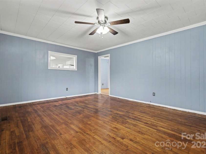 119 Moore Drive, Gastonia, NC 28056.  MLS# CAR4332115, YatesRealty ID 2865. The living area features hardwood floors that add character and warmth, complemented by natural light, creating a comfortable and welcoming space ideal for relaxing or entertaining.