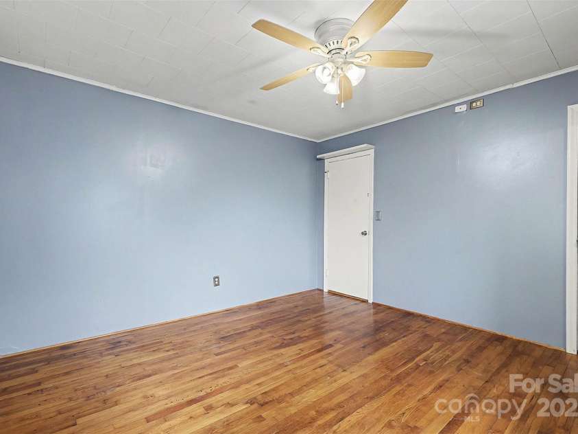119 Moore Drive, Gastonia, NC 28056.  MLS# CAR4332115, YatesRealty ID 2865. Well-sized bedroom (2) featuring hardwood floors and a ceiling fan with light for added comfort. The simple, functional layout offers flexibility for a guest room, home office, or additional bedroom. Clean finishes and natur