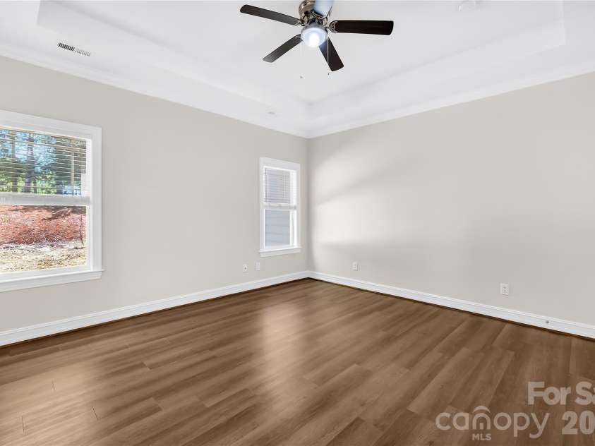 20236 Colony Point Lane, Cornelius, NC 28031.  MLS# CAR4378155, YatesRealty ID 28667. Primary Bedroom on main level with Trey Ceiling and Ceiling Fan
