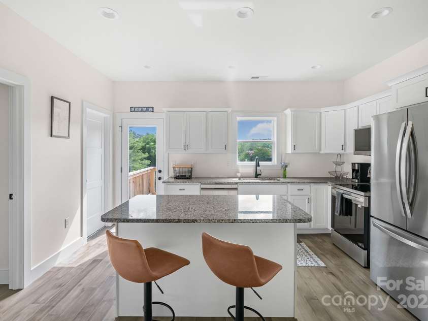 8 Green Tree Lane, Asheville, NC 28805.  MLS# CAR4289236, YatesRealty ID 2868. Bright kitchen with island and bar seats