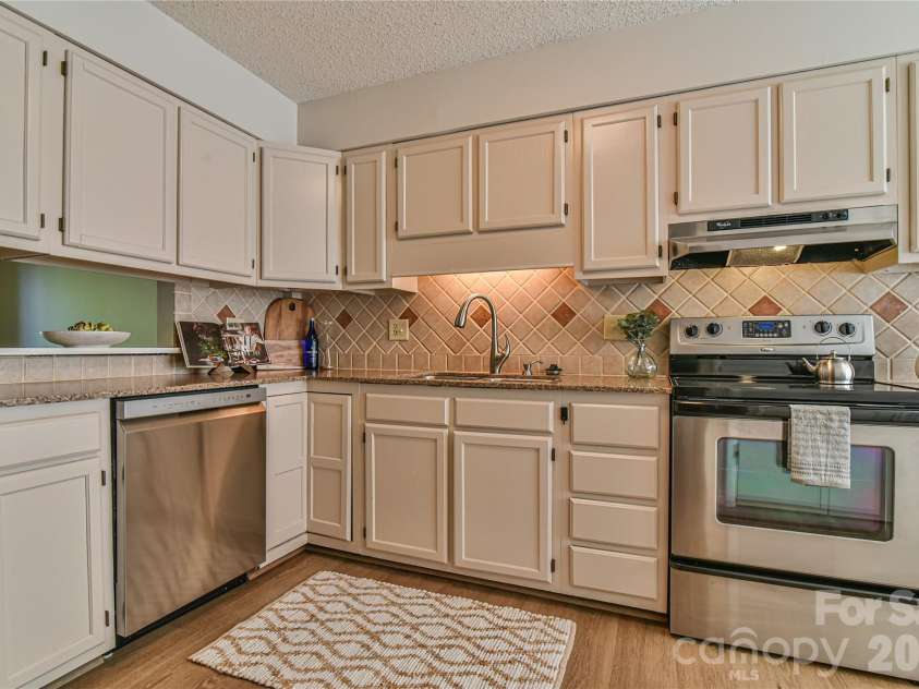 63 Hollybrook Drive, Asheville, NC 28803.  MLS# CAR4383971, YatesRealty ID 28682. Kitchen with granite counters and tile back splash.
