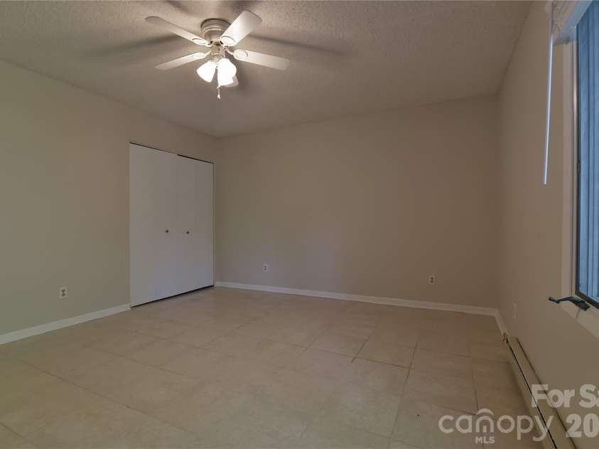 63 Hollybrook Drive, Asheville, NC 28803.  MLS# CAR4383971, YatesRealty ID 28682. Lower level bedroom.